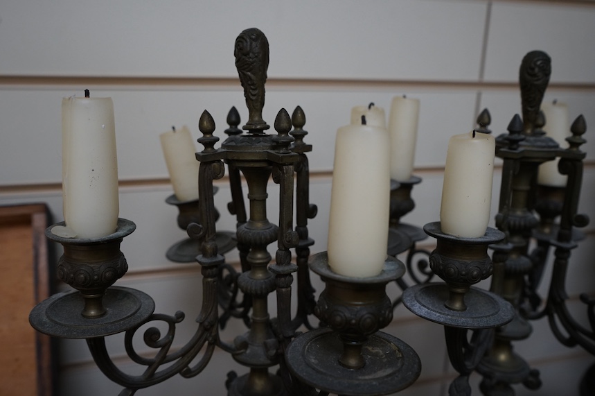 A pair of four branch candelabra raised on slate bases with paw feet, 62cm high. Condition - fair/good